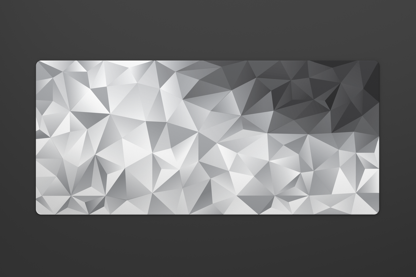 Overhead shot of a large 900 by 400 millimeter mousepad with a white to black geometric gradient pattern