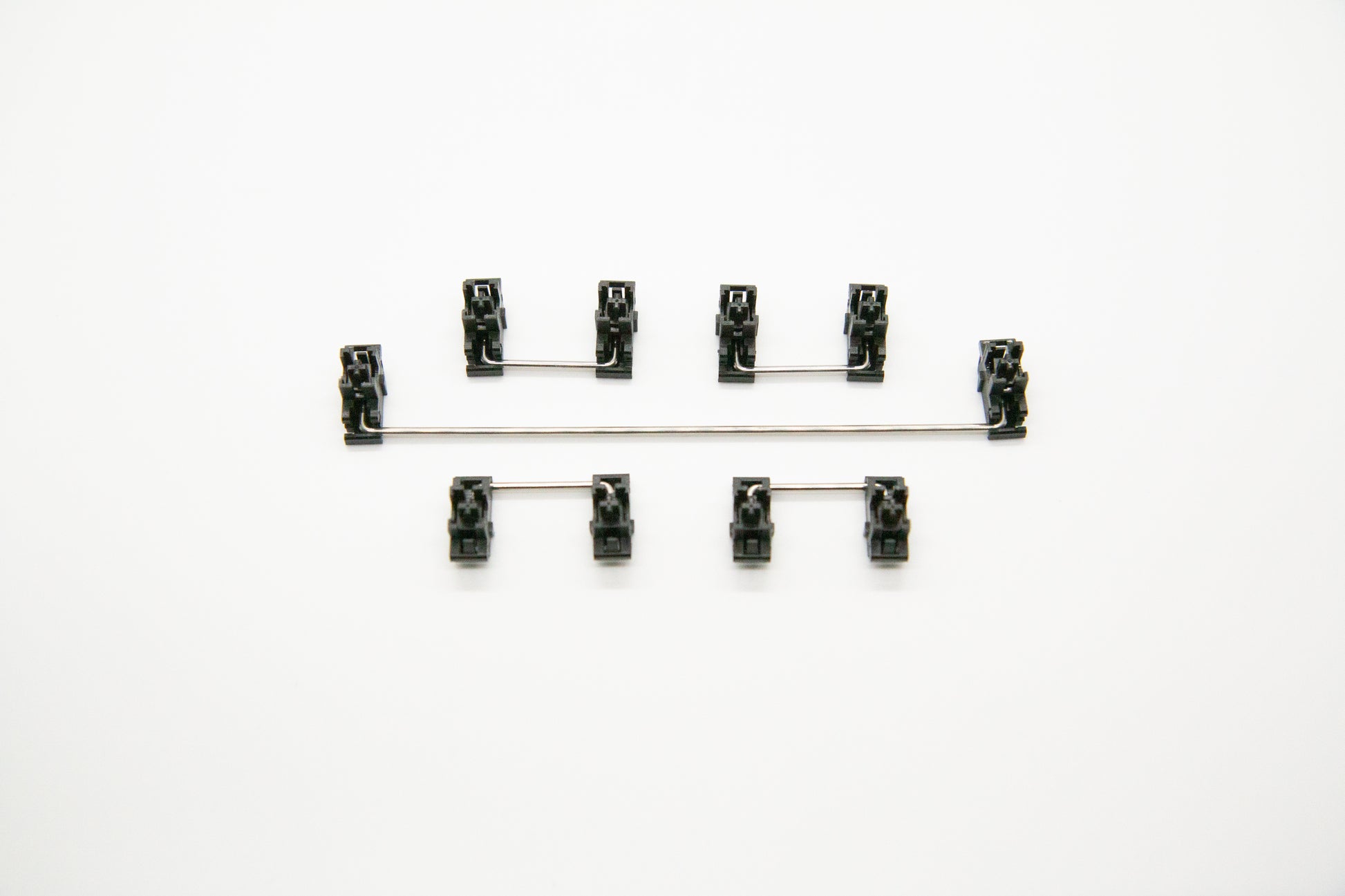 Overhead shot of PCB mounted black mechanical keyboard Durock stabilizer kit in 7u configuration with screws and washers