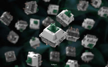 Load image into Gallery viewer, Close-up shot of a BBN Linear mechanical keyboard switch with an assortment of BBN Linear switches falling behind it with a green background with dark green leaves

