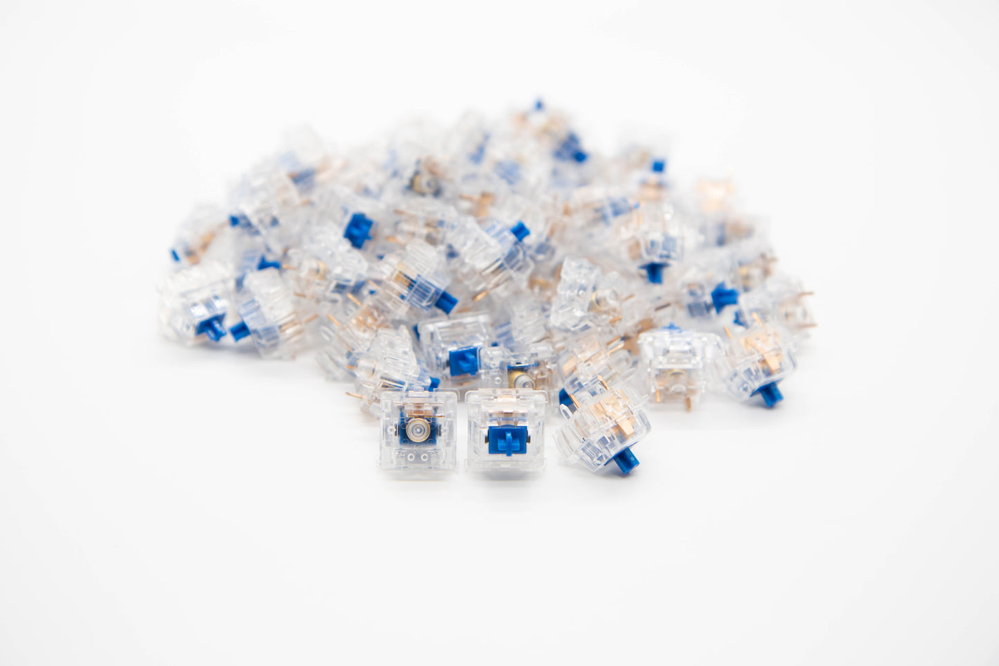 Close-up shot of a pile of Durock Dolphin mechanical keyboard switches featuring transparent housing and blue stems