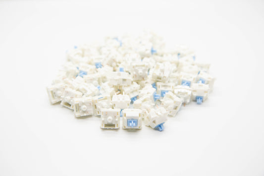 Close up shot of a pile of Blue Velvet Linear themed mechanical keyboard switches featuring white housing and baby blue stems