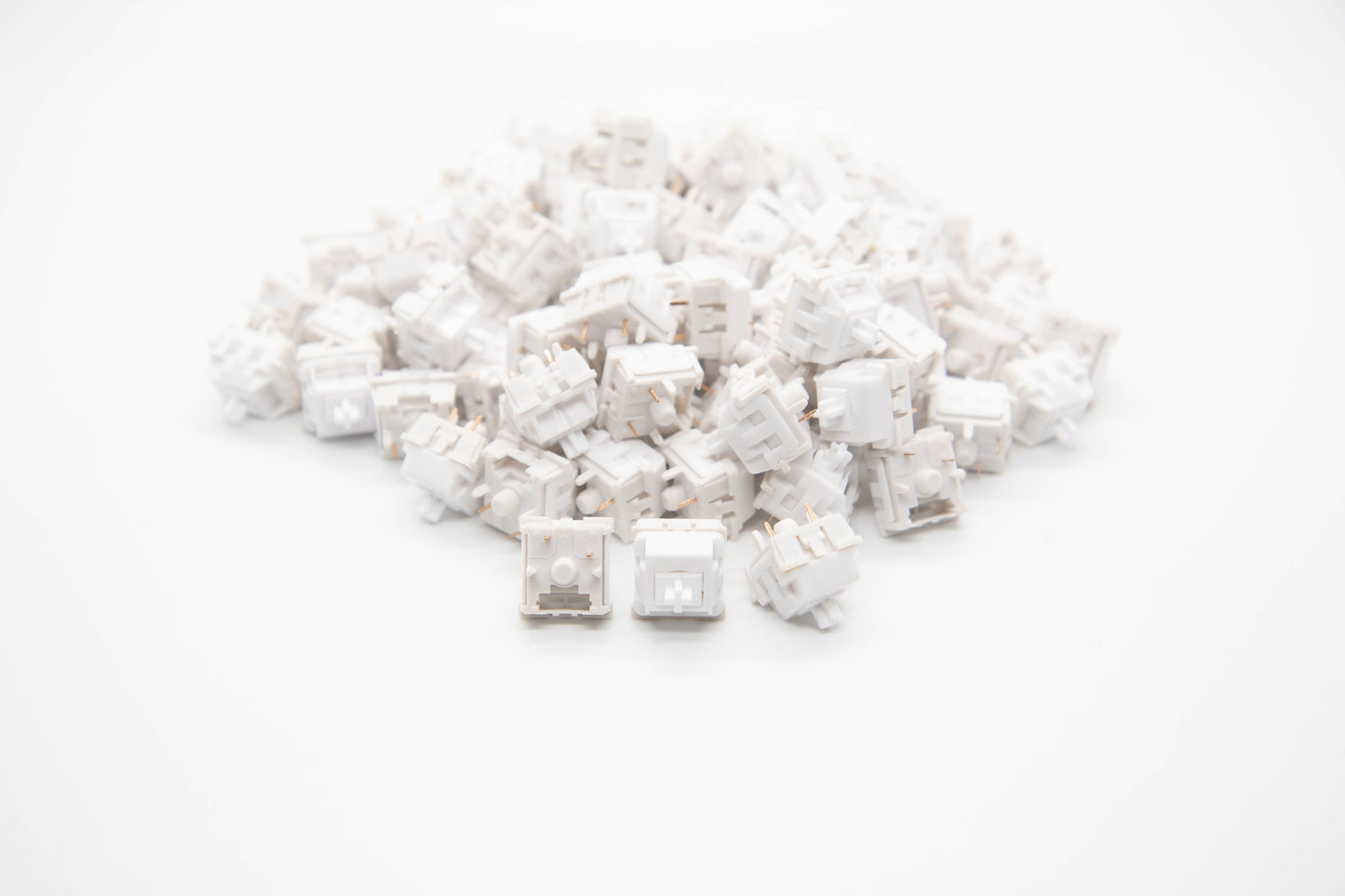 Close-up shot of a pile of KTT Monochrome Chalk mechanical keyboard switches featuring white housing and white stems