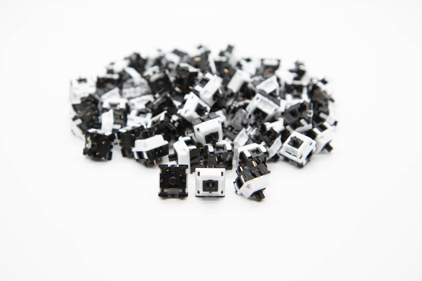 Close-up shot of a pile of KTT Monochrome Marble mechanical keyboard switches featuring black and white housing and black stems