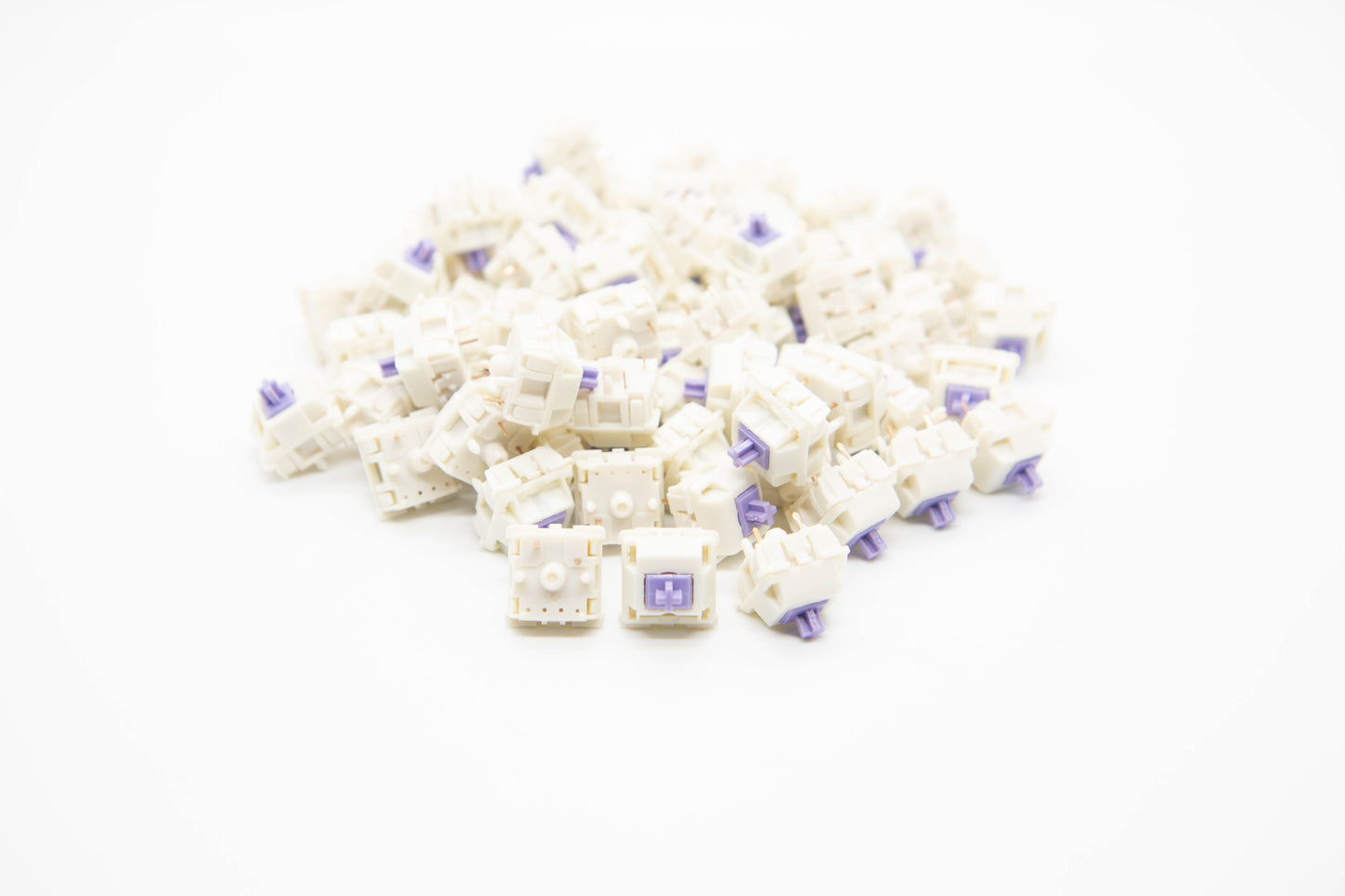 Close-up shot of a pile of SP-Star Polaris Purple mechanical keyboard switches featuring white housing and purple stems