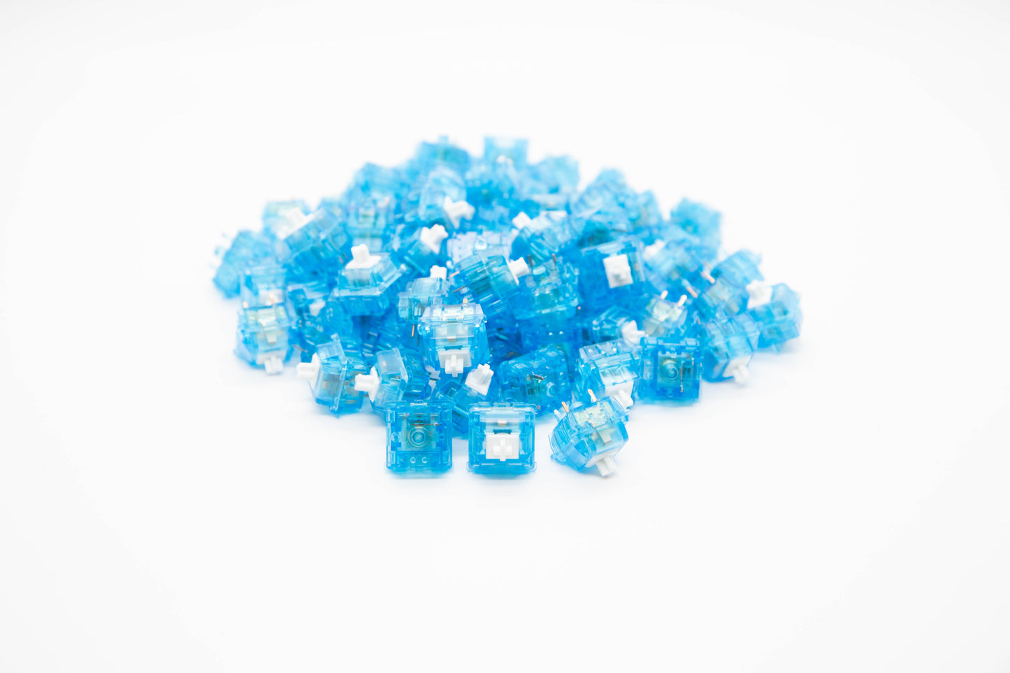Close-up shot of a pile of SP-Star Marble Soda Original mechanical keyboard switches featuring blue transparent housing and white stems