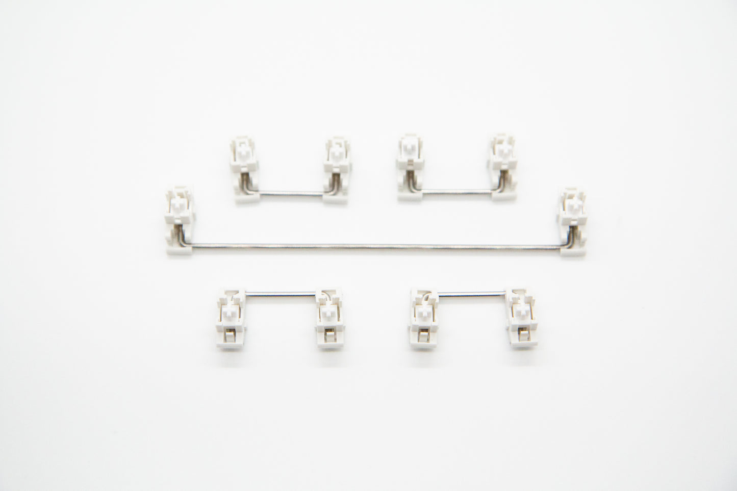 Overhead shot of PCB mounted white mechanical keyboard Durock stabilizer kit in 6.25 configuration with screws and washers