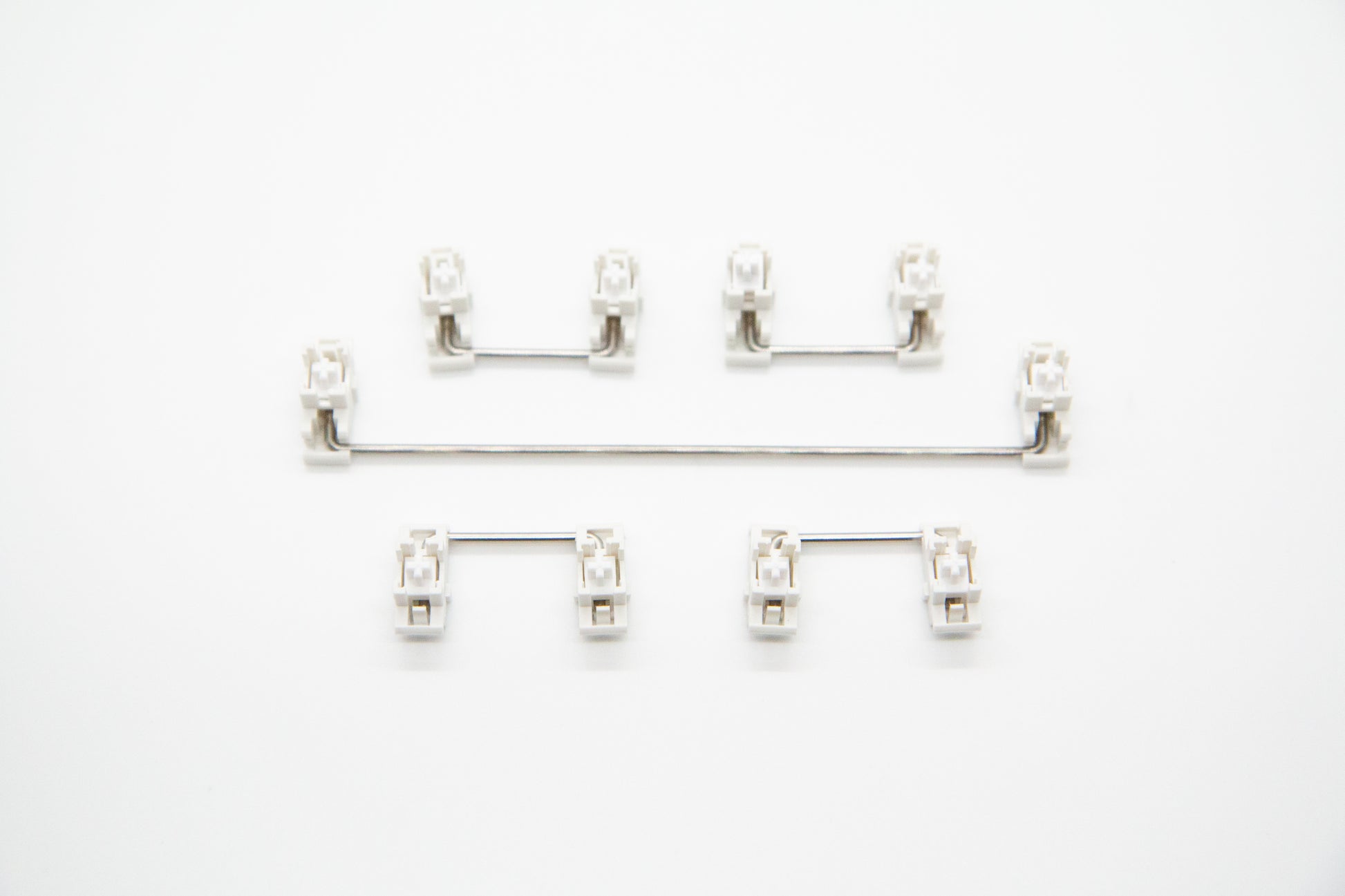 Overhead shot of PCB mounted white mechanical keyboard Durock stabilizer kit in 6.25 configuration with screws and washers
