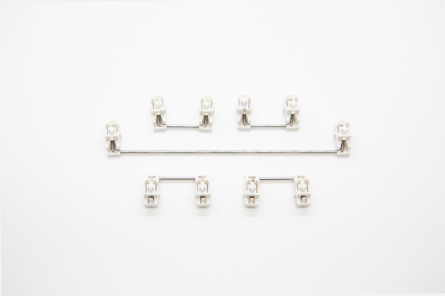 Overhead shot of PCB mounted white mechanical keyboard Durock stabilizer kit in 7u configuration with screws and washers