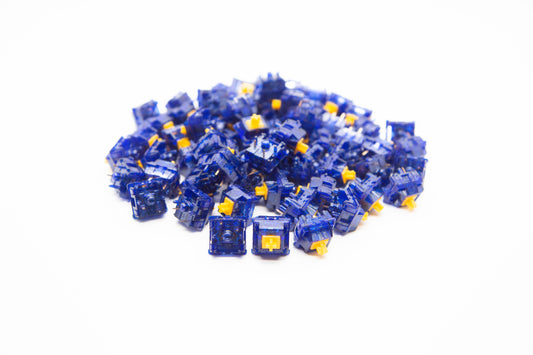 Close-up shot of a pile of Tecsee Sapphire mechanical keyboard switches featuring bold blue transparent housing and yellow stems