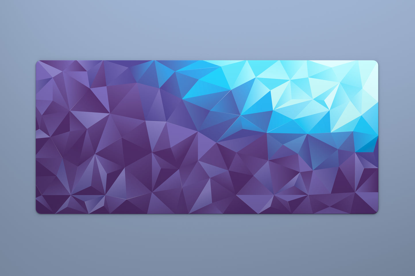 Overhead shot of a large 900 by 400 millimeter mousepad with a purple to blue geometric gradient pattern
