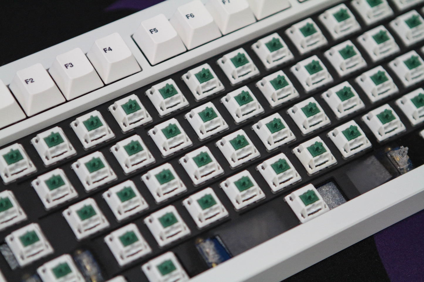 Close-up shot of BBN Linear switches in a keyboard with keycaps removed